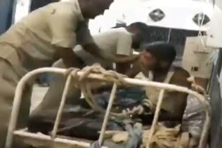 policeman beating prisoner