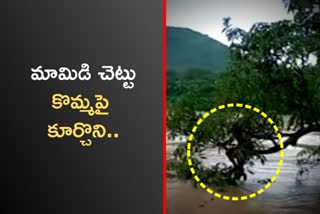 man stuck in flood water