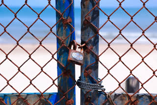 Entrance to a beach is barricaded and locked in Vung Tau, Vietnam, Monday, Sept. 20, 2021. The roadblocks and barricades make the streets of this southern Vietnamese city look like they did during the war that ended almost 50 years ago. But this time, the battle is being fought against the rampaging coronavirus.