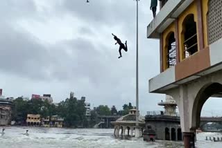 Youth swimming in flood water nashik