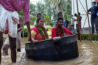 Bride, groom reach flooded hall in cooking vessel