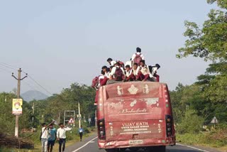 students travelling on roof of bus in giridih