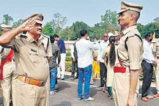 police father and son salute each other