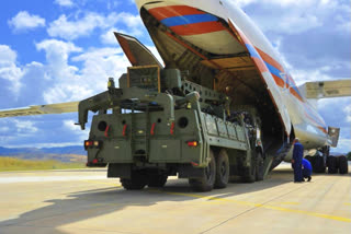 Military vehicles and equipment, parts of the S-400 air defense systems, are unloaded from a Russian transport aircraft