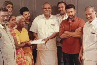 Surya presents a cheque for Rs 15 lakh