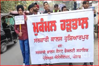 Guest faculty assistant professors sitting on the protest staged a protest march