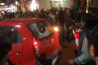 man throw stone on car