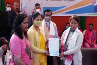 Ajanta Neog distributes cheques to microfinance indebted women