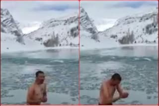 devotee taking holy dip in chandrabhaga river in himachal