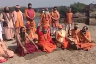 Saints sit on broken dam of Shipra river ujjain