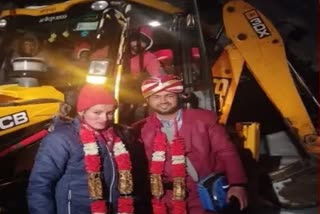 bride and groom takes jcb ride