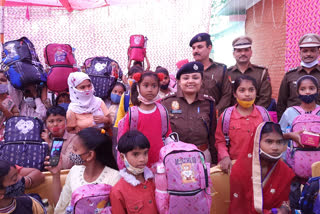 Distribution of school bags to children in Okhla Chowki