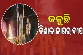 lighting the largest jagara lamp in lokanath temple at puri