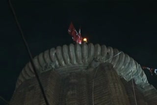 Devotees break their day long fast after Mahadipa raised atop the Lingaraj temple in Bhubaneswar