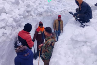 Workers engaged in removing snow from Kedarnath road