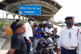 Traffic police cut challans for two wheelers passing through subway