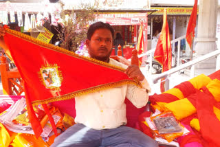 Muslim Tailor making flag for Hindus