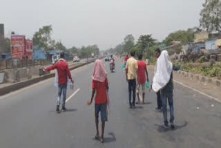 TMC distributes water and food on National Highway in Jamuria