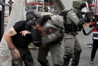 Israeli police clash with stone-pelting people at a holy site in Jerusalem