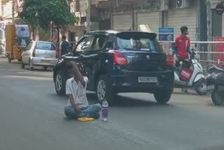 Drunk man sitting in middle road bengaluru