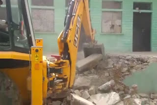 Bulldozer at the house of accused