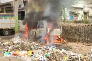 Fire in car parked near garbage heap