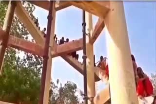 Women climbed on water tank