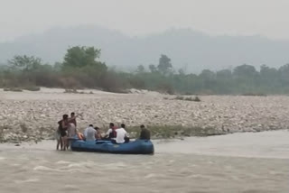 Two youths stranded in the middle of Ganges