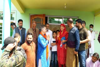 Ravinder Raina consoles the family of slain police constable Riyaz Ahmed