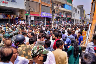 Residents of Shaheen Bagh surround officials during a demolition drive in New Delhi, Monday, May 9, 2022. Authorities in New Delhi stopped a demolition drive in a Muslim-dominated neighborhood after hundreds of residents and a number of opposition party workers gathered in protest Monday. No buildings were razed down before the bulldozers retreated.