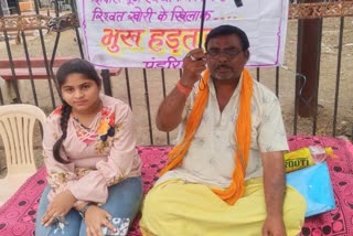 man sitting with daughter on hunger strike in  Kawardha