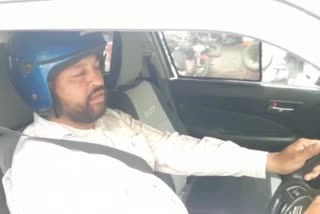 young man rides a CAR wearing a helmet laughs at Delhis traffic police