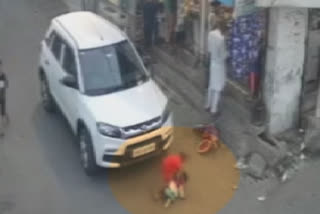 Tiny tot knocked down by a car due to driver's negligence