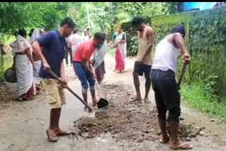 people repair roads in lakhimpur
