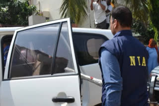 nia raid in kashmir ,father son detained
