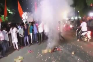 Supporters cheer in front of the houseat