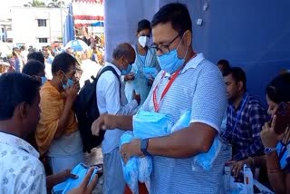 mask distributing by district health department at puri bahuda yatra