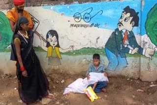 Innocent sitting on the roadside carrying the dead body