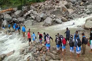 Students crossed overflowing creek