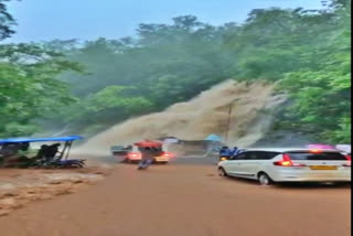 Watch: Rainwater surges down hillside amid heavy downpour