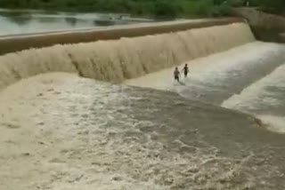 children's play at check dam amid rainfall in tamilnadu