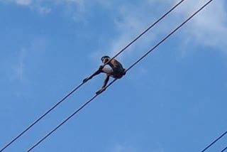 young man climbing in power tower