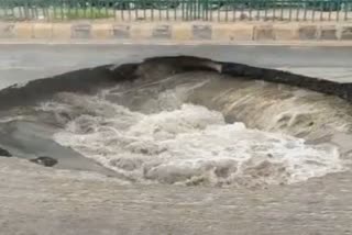 PIT ON ROAD DUE TO HEAVY RAIN FALL IN AHMEDABAD FLOOD SITUATION