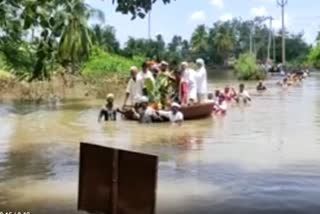 People carried the body of a woman in a raft near Kampli Kote