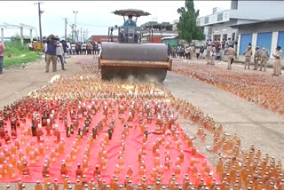 Trampled with a road roller. Liquor worth Rs. 2 crores were destroyed(Visual Interest)  Destroyed liquor bottles worth about Rs 2 crore using road roller  Destroyed bottles of liquor using road roller  വിജയവാഡയില്‍ മദ്യക്കുപ്പികള്‍ക്ക് മുകളില്‍ റോഡ് റോളര്‍ കയറ്റിയിറക്കി പൊലീസ്  വിജയവാഡയില്‍ പൊലീസ് നശിപ്പിച്ചത് 2 കോടി രൂപയുടെ മദ്യം  62000 കുപ്പി മദ്യം റോഡ് റോളര്‍ കയറ്റി നശിപ്പിച്ചു