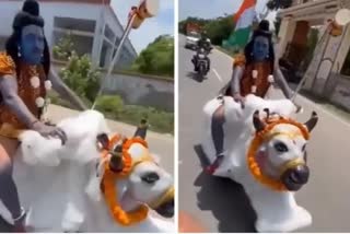 Man dressed up as Shiva rides over bike resembling 'Nandi'