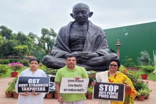 Suspended MPs infront of Gandhi Statue