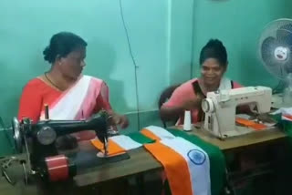 women busy making national flag in nalbari