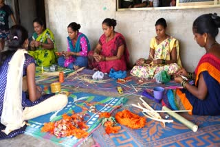 Tribal women making artistic rakhis