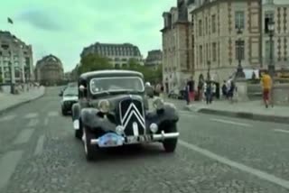 Hundreds of vintage cars parade through streets of Paris